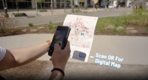 A visitor scanning a QR code to access an interactive digital map